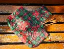 Wrist Xmas Poinsettia Plaid Green Red L on the Floor.webp